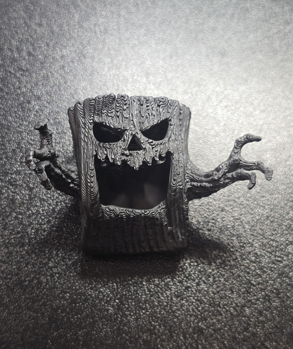 Hideaway - close-up of the hollow face and reaching branch hands