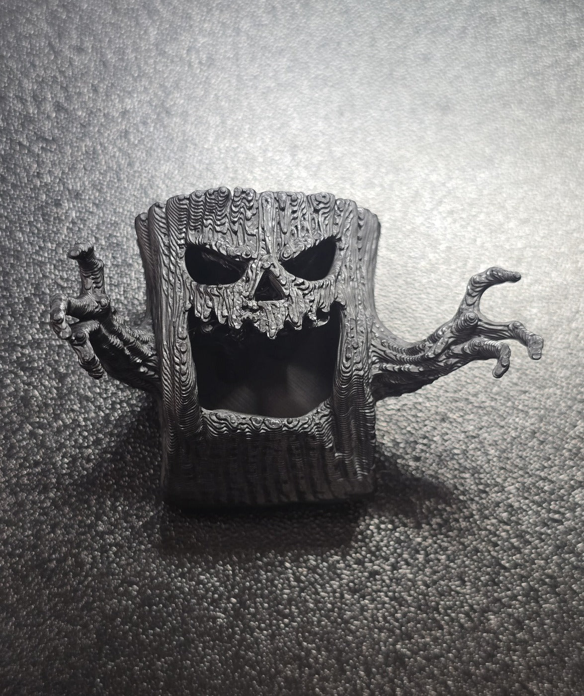 Hideaway - close-up of the hollow face and reaching branch hands